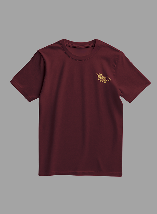Maroon t-shirt with gold designs on a gray background