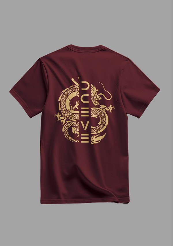 Maroon t-shirt with gold designs on a gray background